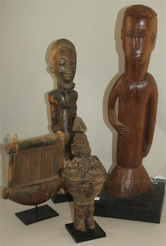 An African Ivory Coast Baule figure of a standing male, largest figure 20.5in.